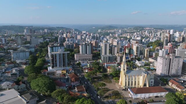 Downtown Bento Gon&ccedil;alves aerial view with Cristo Rei Church and dense city skyline, captured in D-Log with 10-bit color using a Hasselblad sensor.