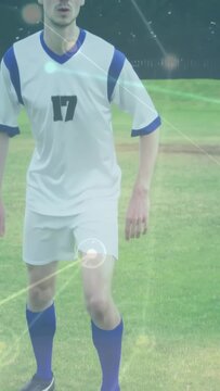 Vertical video: Soccer player reading play, planting foot, swinging to clear, falling, green HUDs