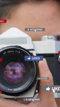 Vertical video: Woman holding SLR cursor tapping LIKE turning LIKED badges around lens raising ROI