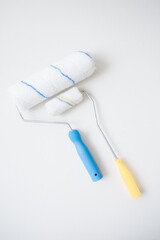 Obraz premium Paint rollers on a white background for home renovation and DIY painting. 