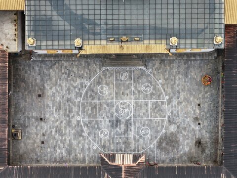 Aerial view of an inner courtyard with intricate white patterns on gray stone, Dongzhulin Monastery, Yunnan, China.