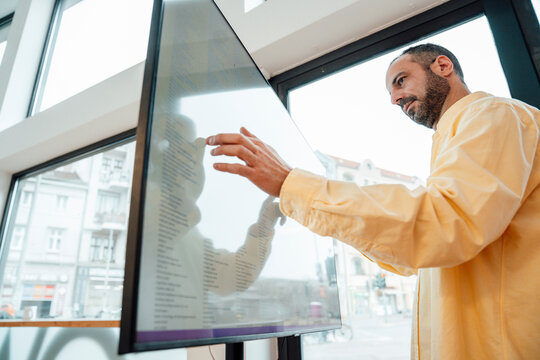 Developer planning project on large screen in modern workspace