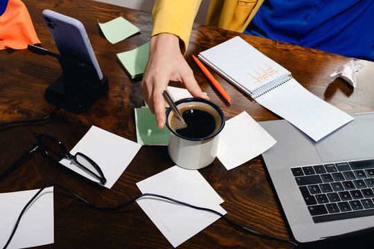 Morning coffee break at home office desk with laptop and notes