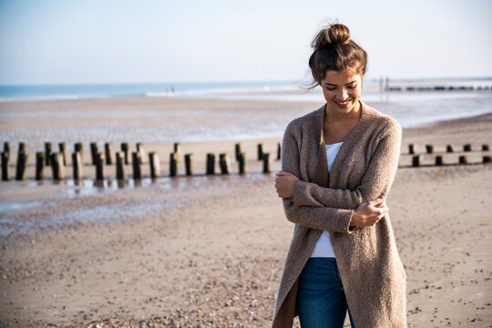 Smiling woman enjoying a relaxed moment at the beach outdoors