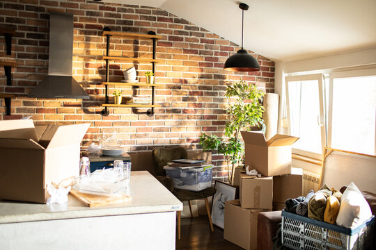 Moving boxes in a sunny loft kitchen