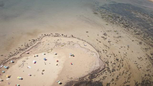 Drone Footage centred on island in Grado, Italy, part of a broader Coastline scene captured During the Day. Useful as travel tourism for commercial projects.
