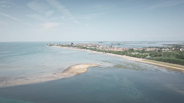 Drone Footage of Coastline, featuring island, captured at daytime in Grado, Italy. Suitable for Travel tourism in commercial productions, corporate videos, and marketing content. Shot in 4K.