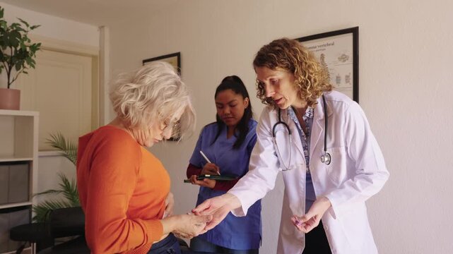 Doctor performing a diabetes blood glucose test on an elderly patient
