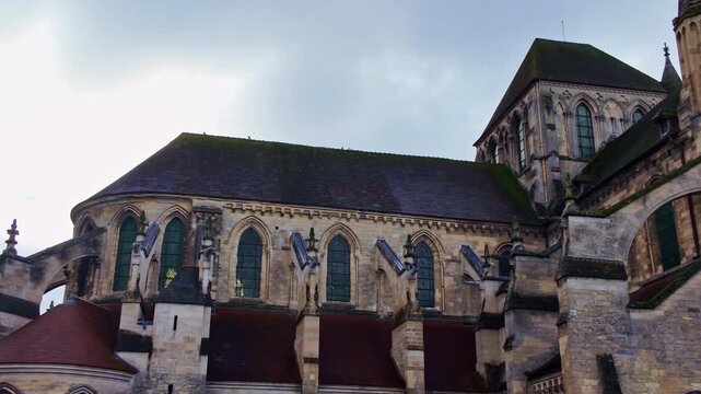 Quick panning shot of the ancient Lisieux Cathedral aka Cathedrale Saint-Pierre de Lisieux church rooftop side, France