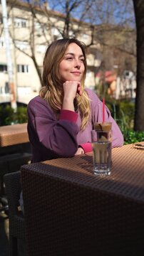 Young woman with sunglasses drinking coffee in a cafe