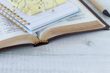 Holy bible and notebook on wooden background. Scripture study and reading, biblical concept. Copy...