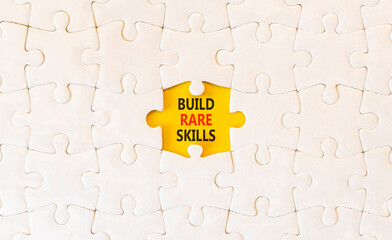 Fototapeta premium Build rare skills words symbol. Concept words Build rare skills on beautiful white puzzles. Beautiful yellow background. Business and build rare skills concept. Copy space.