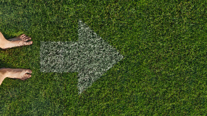 Walking barefoot on soft green grass, closeup. Green grass texture - well-groomed turf in the garden.