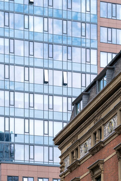 Architecture contrast in Frankfurt Bankenviertel Germany where historic facade edge sits beneath modern skyscraper window grid and skyline