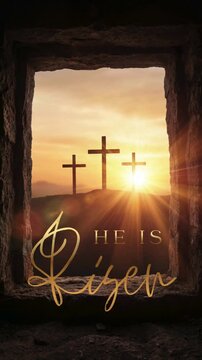 He Is Risen, vertical video of the Resurrection of Christ with a view from the empty tomb of Jesus to Mount Golgotha with crosses in the rays of the sun and golden typography He Is Risen.