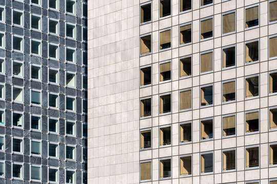 Modern urban office windows on facade architecture with grid pattern repetition creating clean abstract texture background