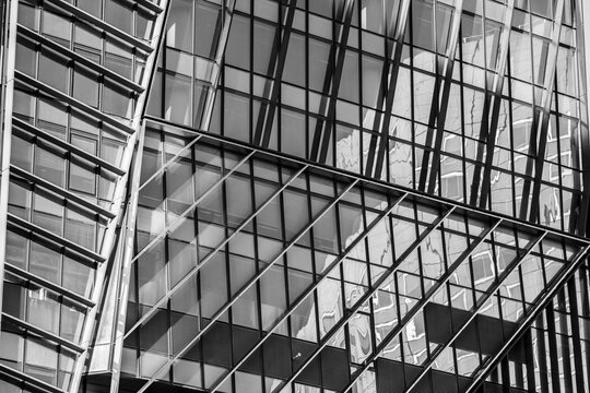 Monochrome modern facade architecture structure of glass and steel with abstract geometry pattern creating industrial texture background