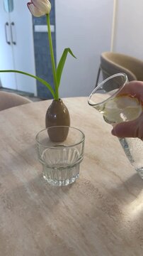 Jug tulip glass pour water into a glass