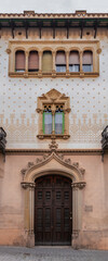 Obraz premium Elements of architectural decoration of buildings, doorways and arches, doors and grills, plaster patterns and stucco molding. On the streets in Barcelona, ​​public places.