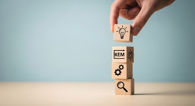 Wooden block puzzle with hand building tower of business icons on light blue background
