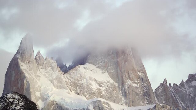 Time-lapse of mount Fitz Roy from Chalten Town before sunrise with dramatic clouds covering the granite walls