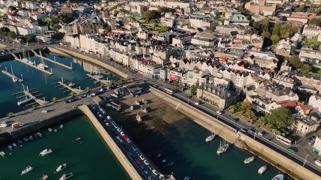 St Peter Port Guernsey panning around from townscape over seafront with detail of inner harbour,Victoria and Albert marinas views over to Havelet Bay in bright late afternoon sunshine