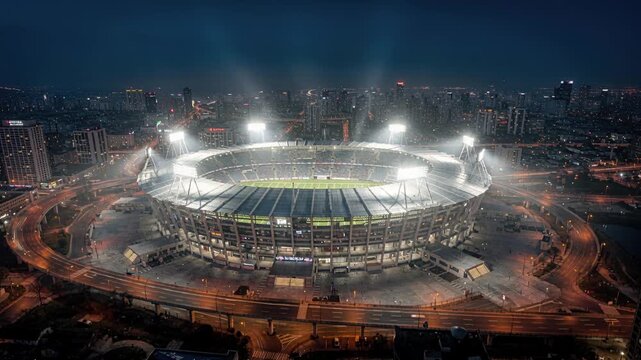 Energetic night football match. Electric atmosphere under stadium lights
