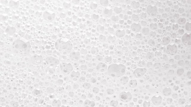 Texture of white soap foam with bubbles abstract background.	