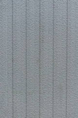 Fototapeta premium Grey vertical textured wall with subtle relief pattern