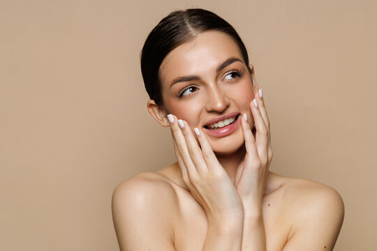 Beautiful young woman after spa treatment on beige background