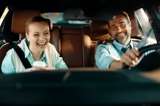 Smiling coworkers carpooling in car interior