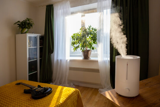 Humidifier spreading steam in a bedroom.