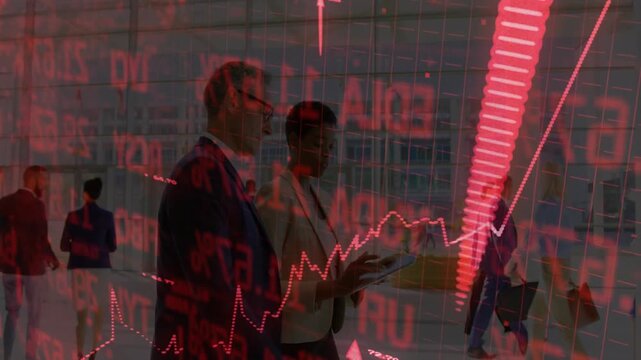 Two colleagues discussing rising stock values using red digital graph overlay in finance office