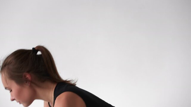 Flexible woman performing a complete sun salutation yoga sequence isolated on a white background in slow motion