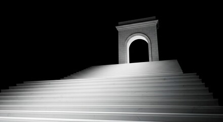 Fototapeta premium A dramatic black and white image of a staircase leading to an archway at night