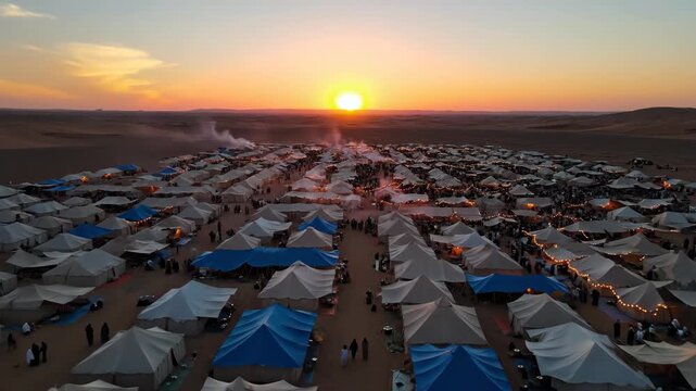 Aerial view of large tent city in desert at sunset