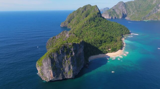 aerial view of Helicopter Island in the Bacuit Archipelago, el nido Palawan with boat at white beach and limestone cliff