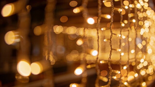 Camera pulling focus, fairy lights sharpening while golden bokeh drifting, showing event decor