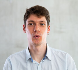 Fototapeta premium Emotions, people and positive concept man expresses different on gray background