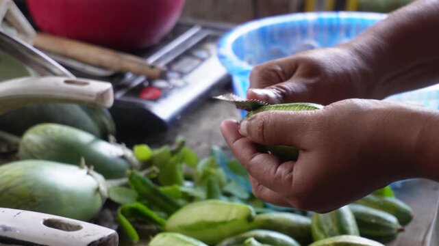 Peeling pointed gourd with traditional Indian cutting tool parwal preparation process