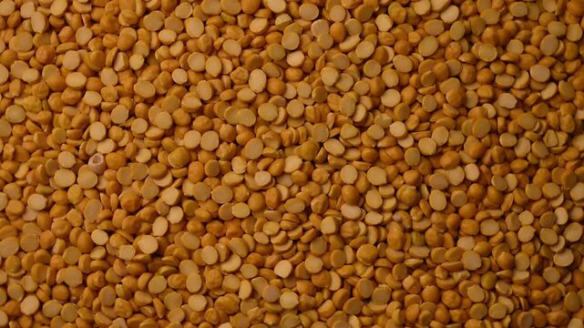 Top View of Chana Dal (Split Chickpeas - Bengal Gram) Rotating on Textured Background &ndash; Food Footage