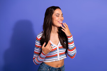 Young female model smiling in striped top against purple background fashion lifestyle