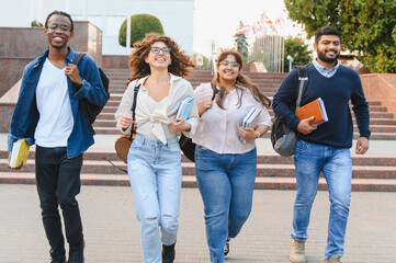 Diverse students walking on campus smiling happily