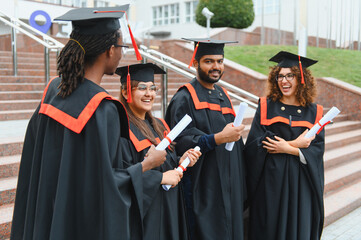 Obraz premium Diverse graduating students celebrating university success concept