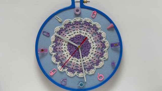 Time for crafting and crocheting. Video of handmade retro clock with knitting and sewing accessories instead of numbers and lace doily for embellished dial. Hobbies and relaxation through needlework