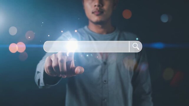Man touching glowing virtual search bar in dark environment representing focused digital information retrieval