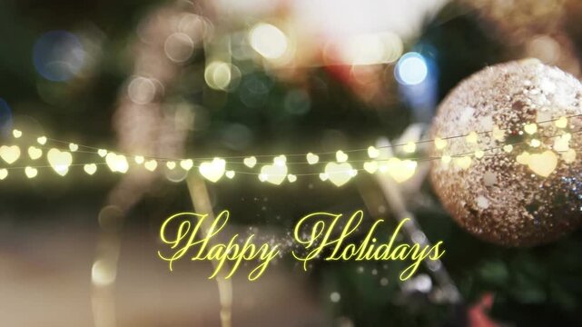 Animation of text, happy holidays, in yellow, over string lights and blurred christmas decorations