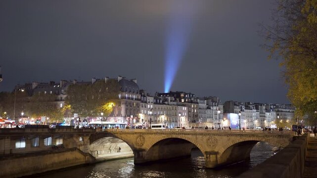 Paris Pont au Change at night with houses and tourists at Seine River in France