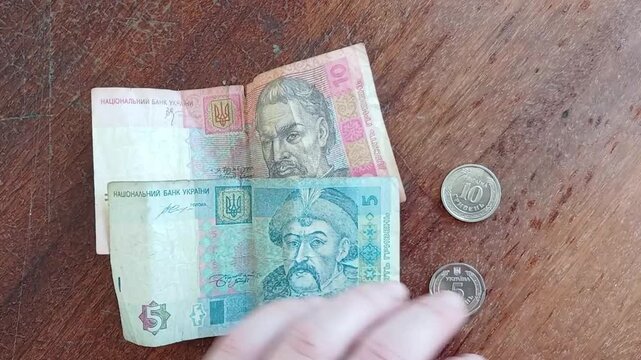 Stock video of Ukrainian 5 and 10 hryvnia banknotes being replaced with kopecks