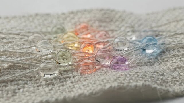 Medium shot of biodegradable scent microcapsules being integrated into textile material highlighting ecofriendly fragrance release solutions for sustainable fabric care.